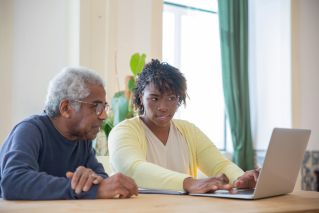 A Man and a Woman using a Laptop Together